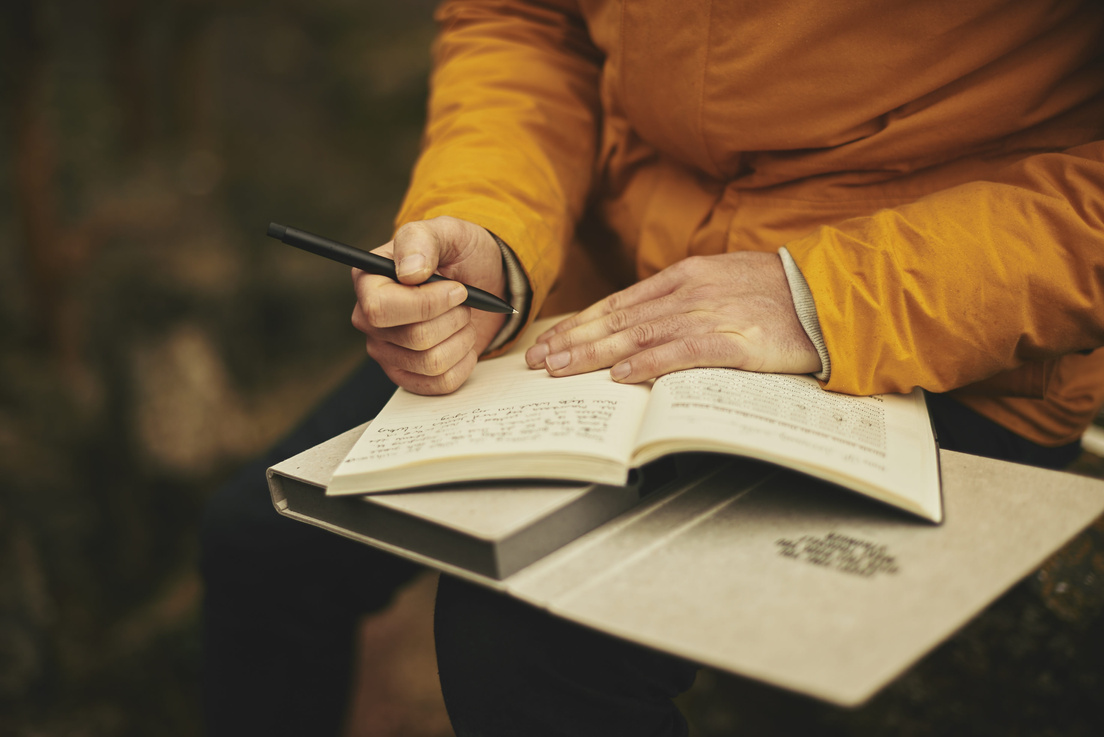 Backpacker Writing in his Journal
